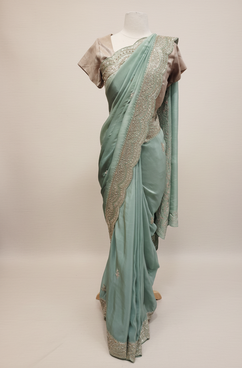 Detail of the delicate scalloped border with fine silver embroidery on this pistachio green saree