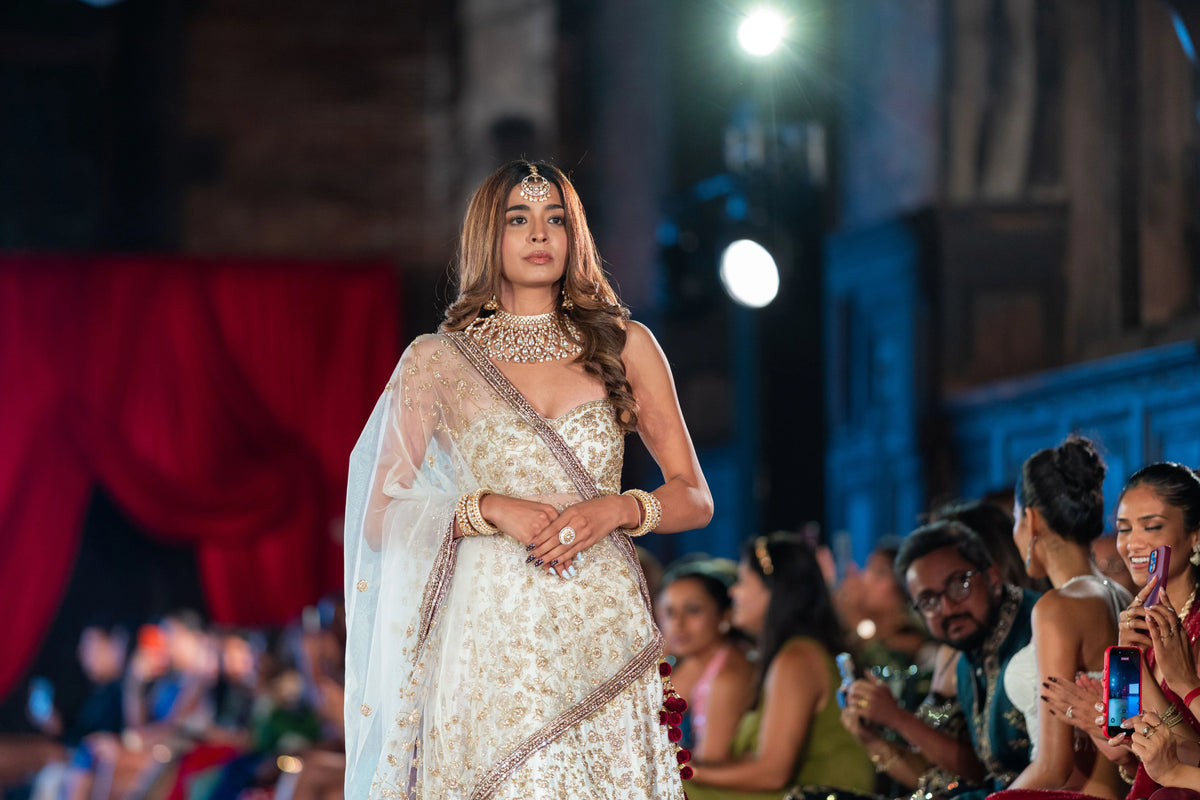 Half-length view of the Venkateshwara ivory net dupatta and embroidered ivory blouse on the runway