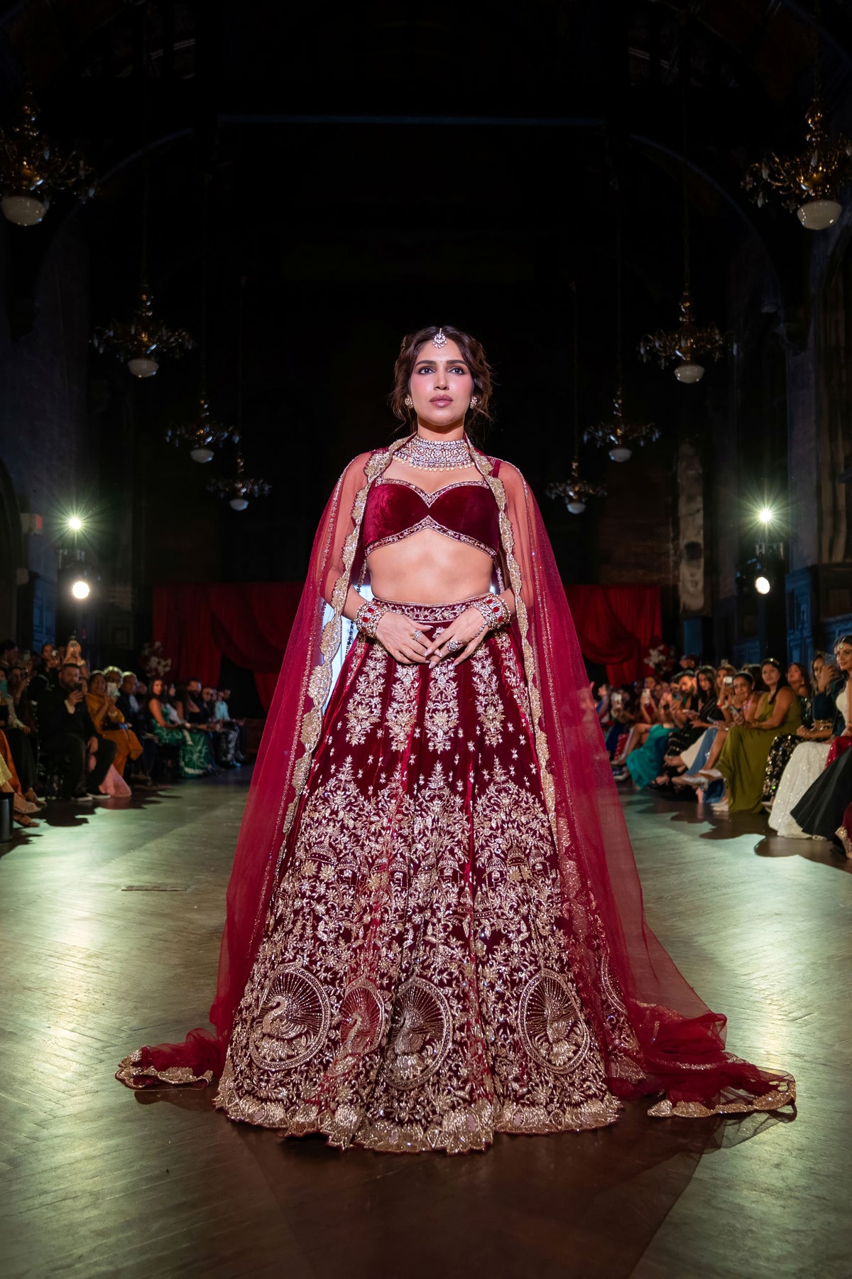 Full-length runway view of the Belur Math maroon velvet lehenga with a red net cape