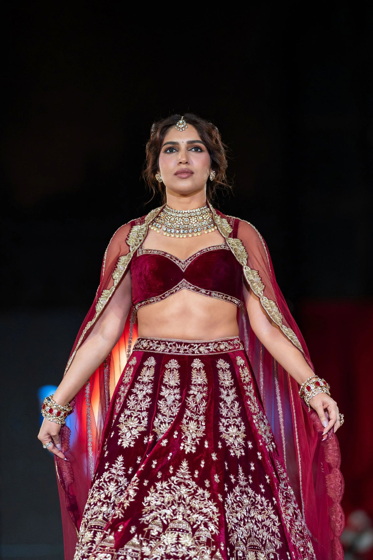 Close view of the Belur Math maroon velvet blouse and lehenga with a red net dupatta draped over the shoulders