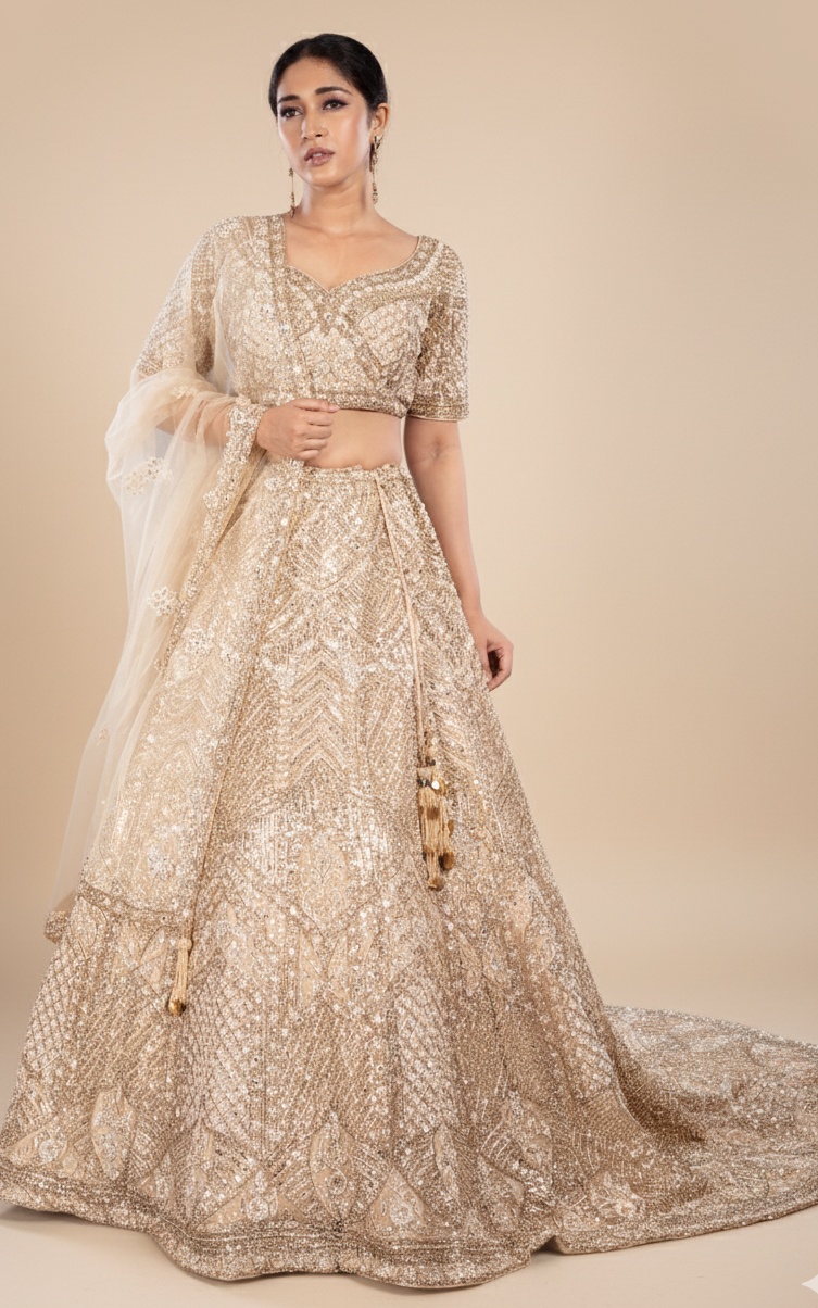 Champagne gold bridal lehenga with a train in net with satin silk lining, Nazranaa