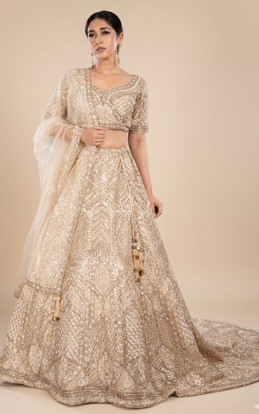 Champagne gold bridal lehenga with a train in net with satin silk lining, Nazranaa