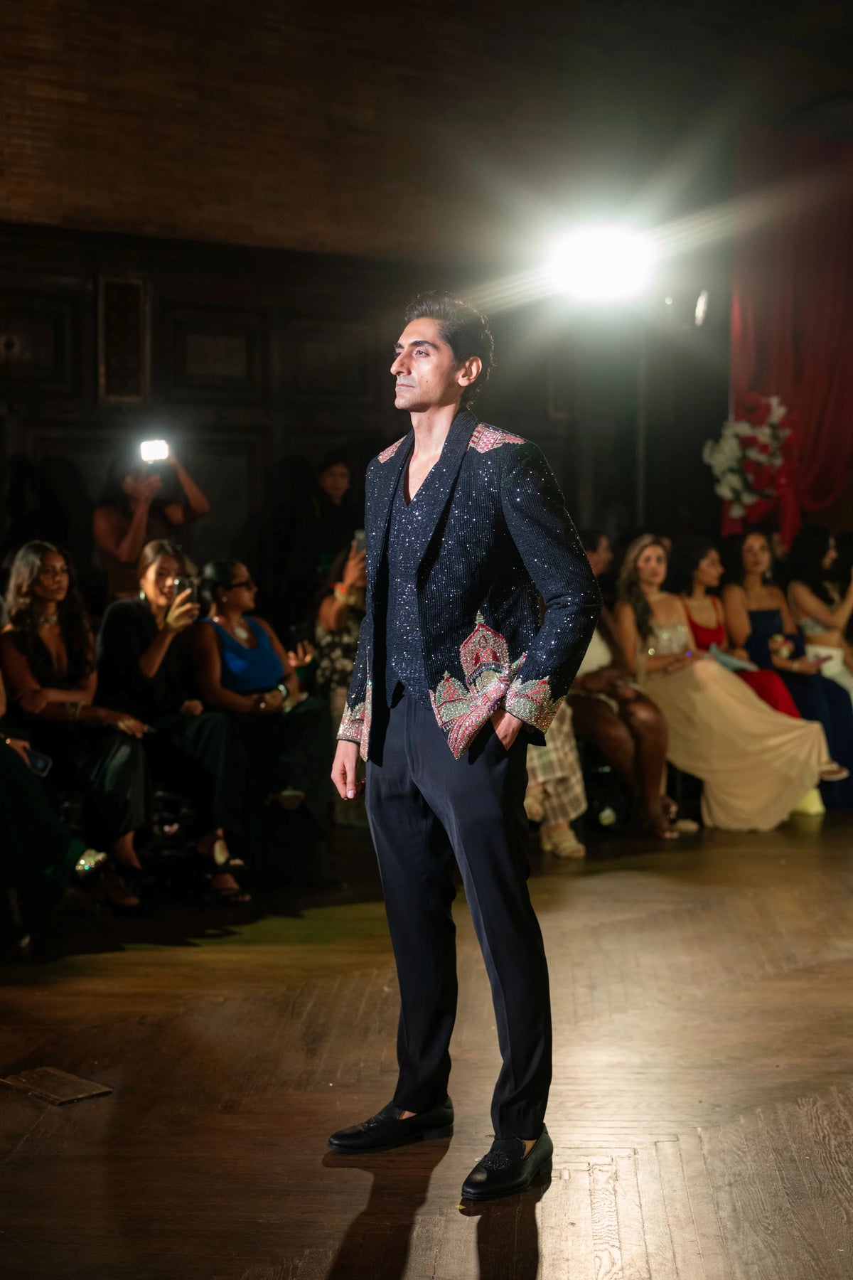 Dakshineshwar Kali black embroidered jacket styled with a hand in the pocket, three-quarter side pose