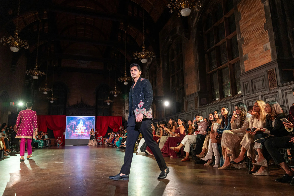 Side-walking view of the Dakshineshwar Kali black jacket with embroidery at the pocket and lapel