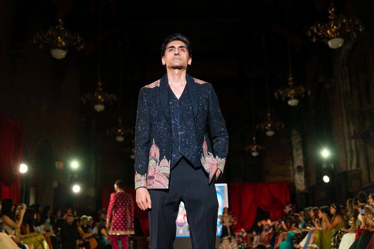 Front view of the Dakshineshwar Kali black jacket with blush motifs on the pockets and black trousers