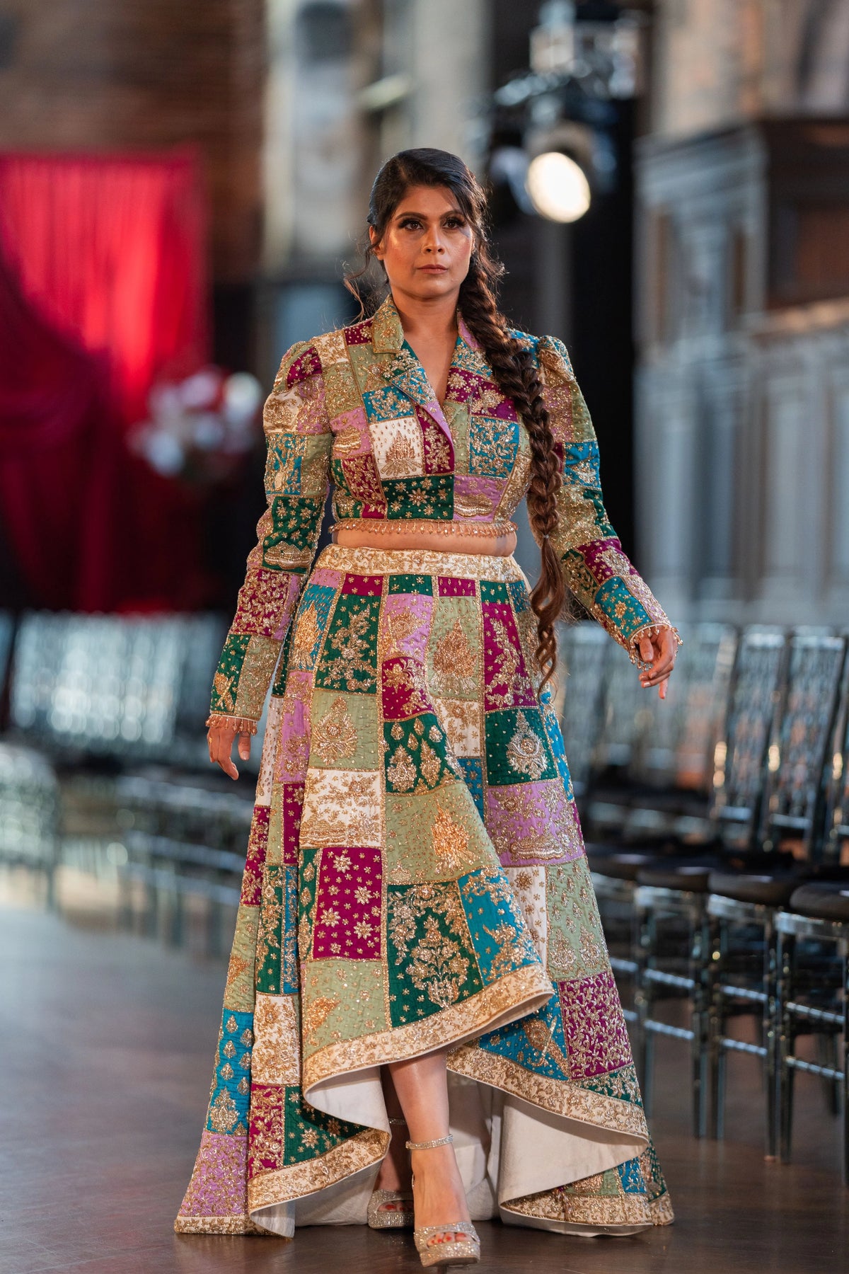 Full-length front of the Holi patchwork lehenga in pink, teal and purple panels with embroidered sleeves