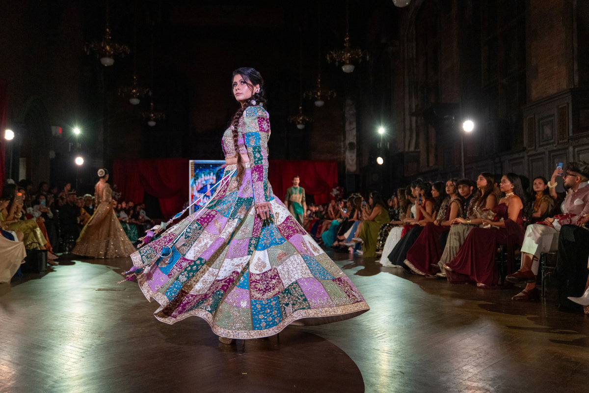 Holi patchwork lehenga skirt swirling in motion as the model turns on the runway