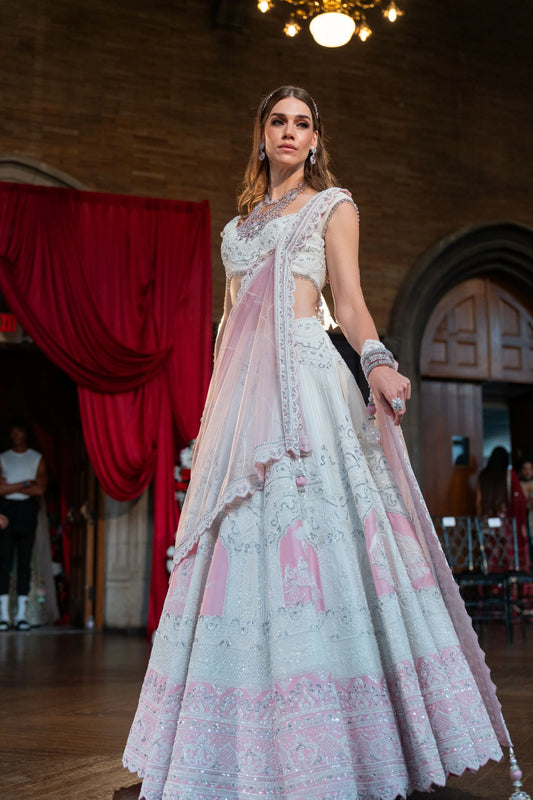 Full-length view of the Prem Mandir ivory lehenga with pink floral panels and a scalloped lace hem