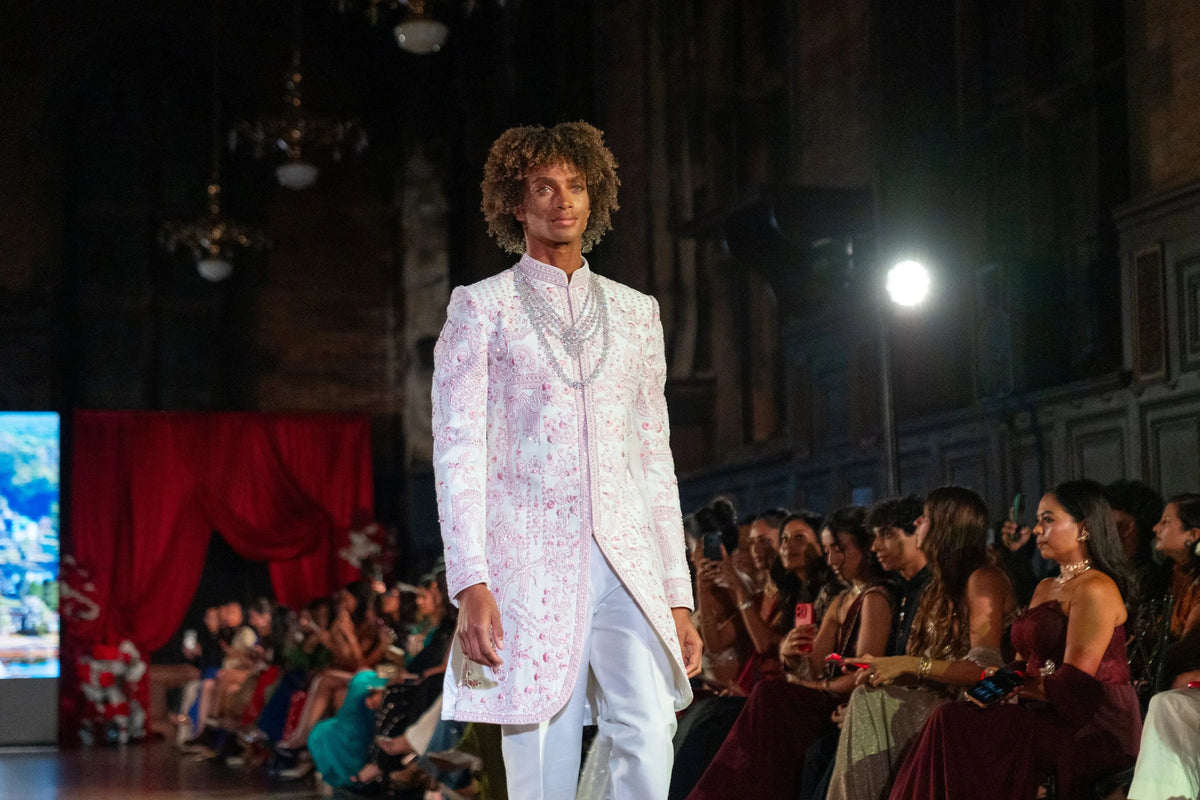 Wide runway view of the Prem Mandir ivory and lilac embroidered sherwani with white trousers