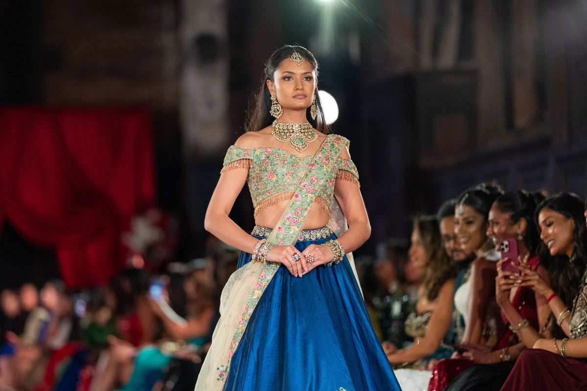 Raas Leela blue lehenga with a floral border, slightly closer wide runway shot