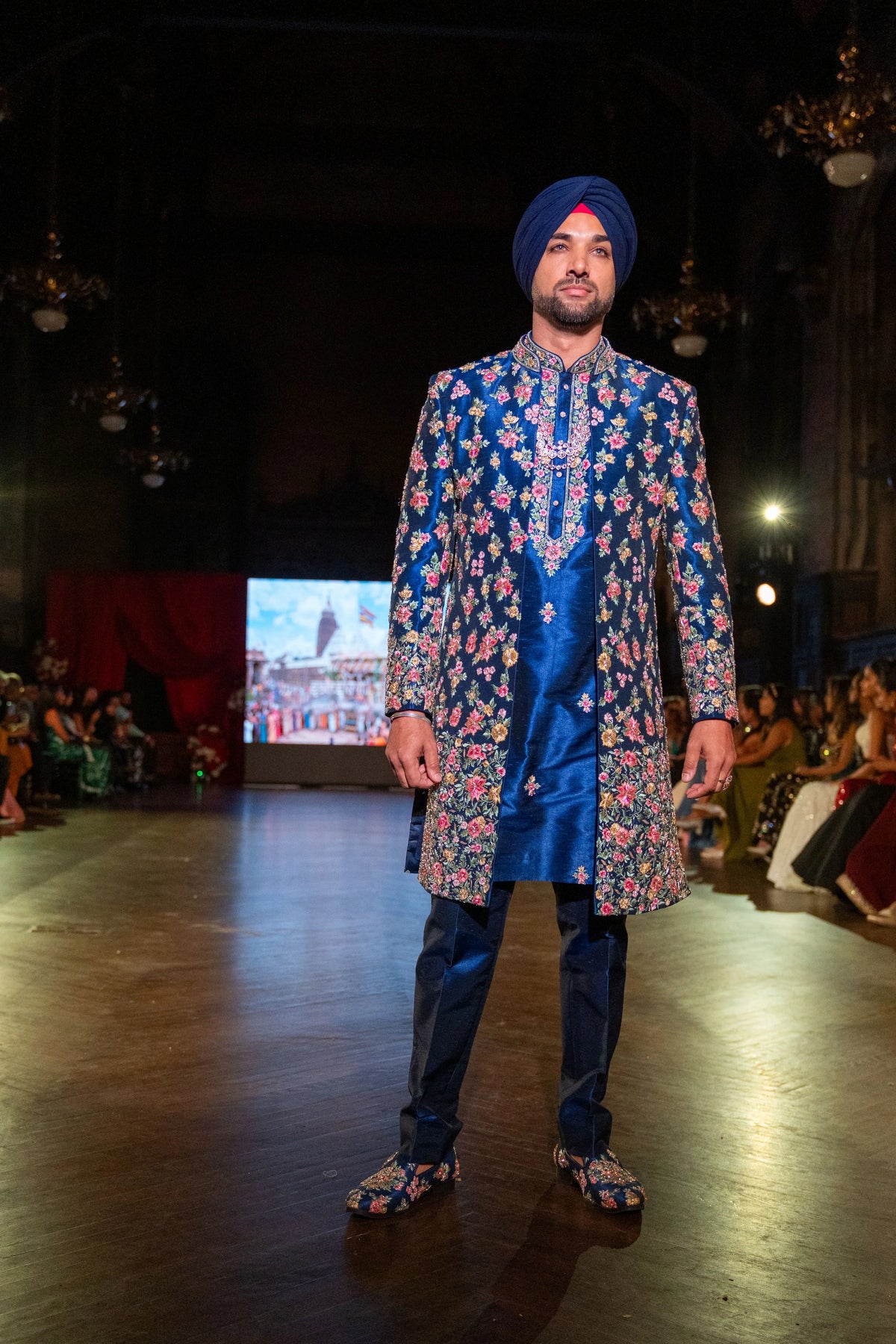 Closer front view of the Raas Leela blue sherwani with a blue kurta and floral embroidery