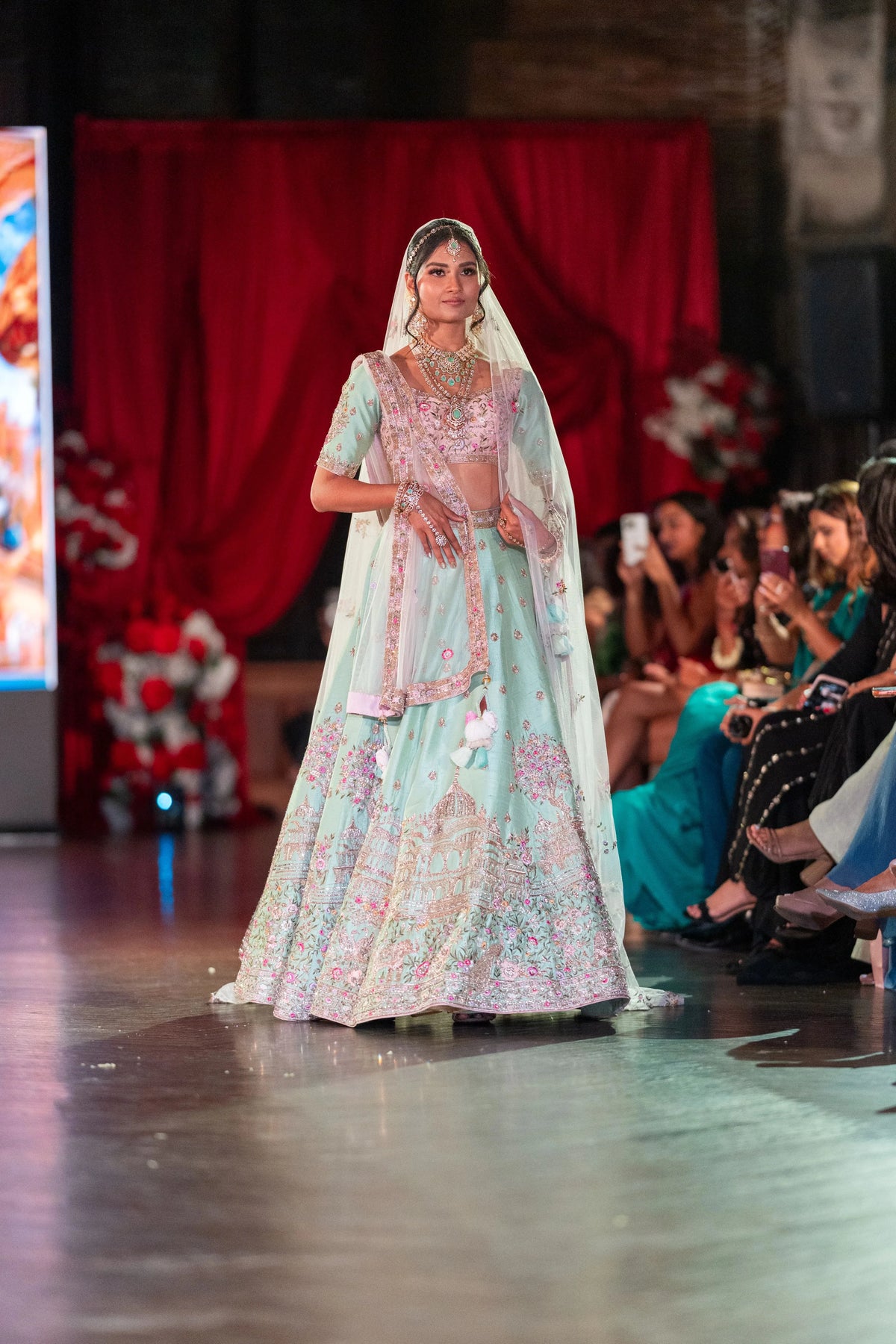 Vrindavan pistachio green lehenga with pink floral embroidery and a tulle veil dupatta, full-length front view