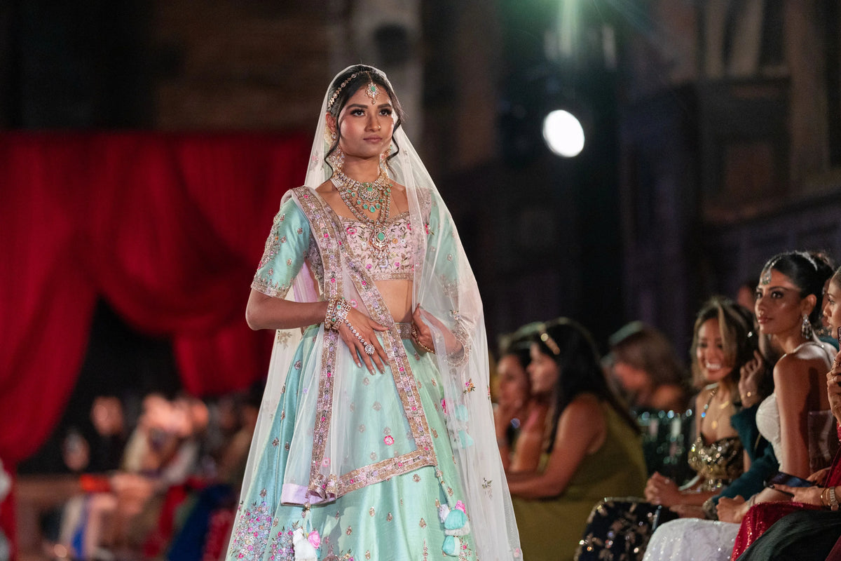 Half-length view of the Vrindavan pistachio blouse with pink floral work and a sheer dupatta over the head