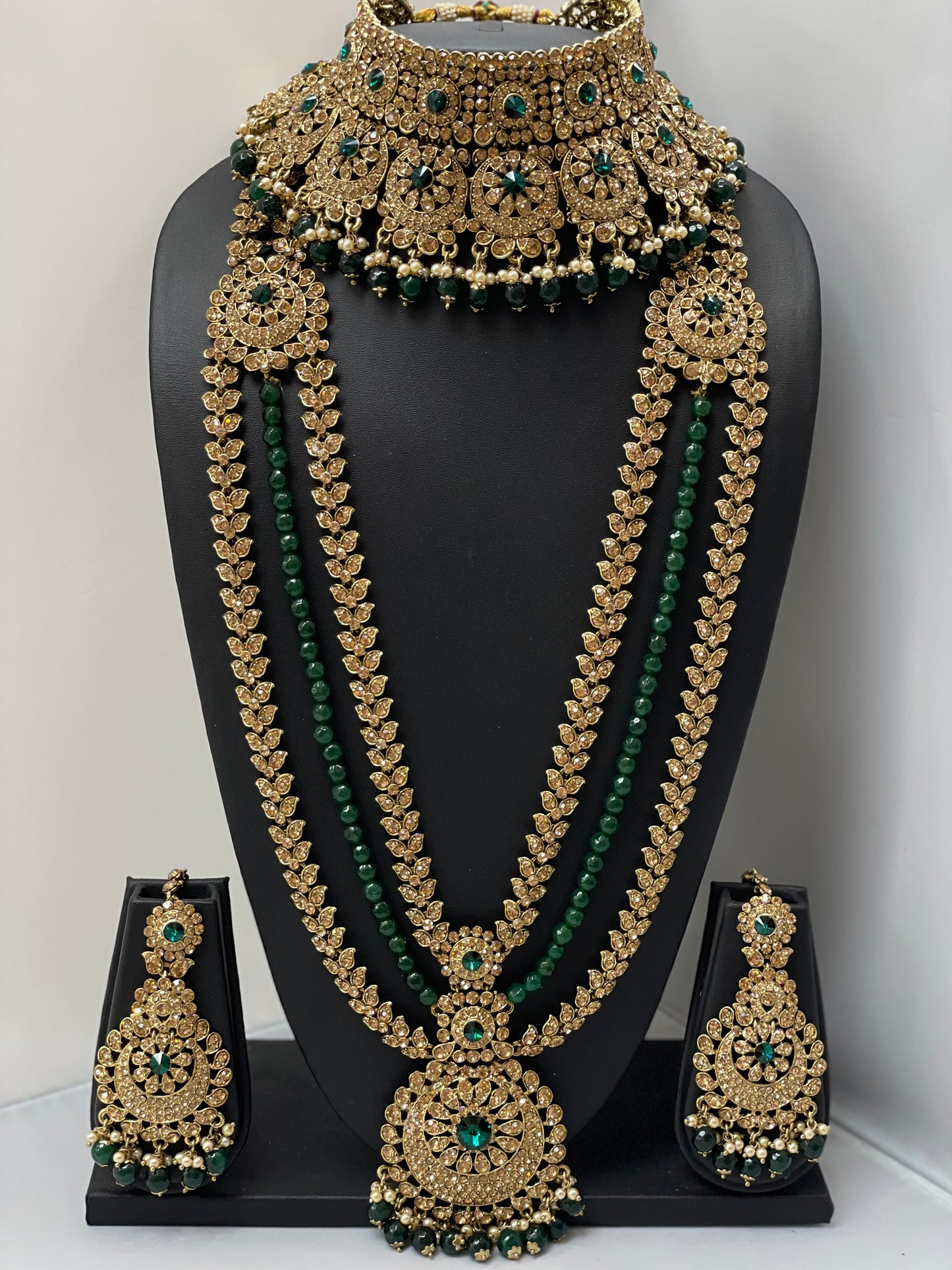 Bridal gold jewelry with emerald accents