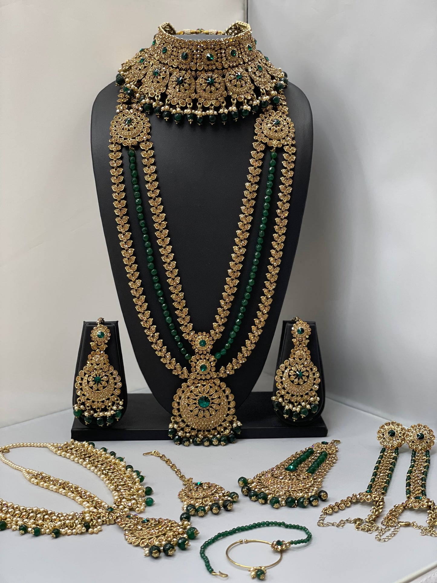 Bridal gold jewelry with emerald accents