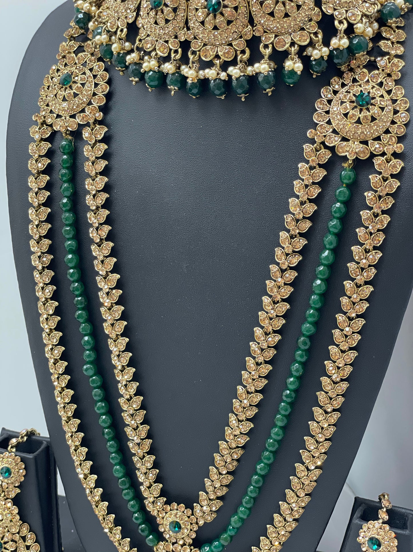 Bridal gold jewelry with emerald accents