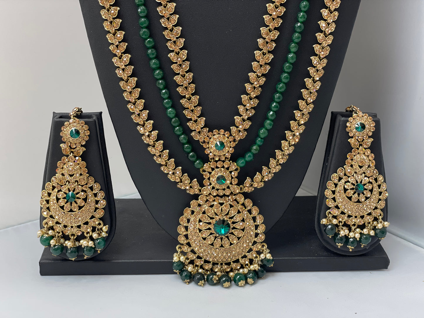 Bridal gold jewelry with emerald accents