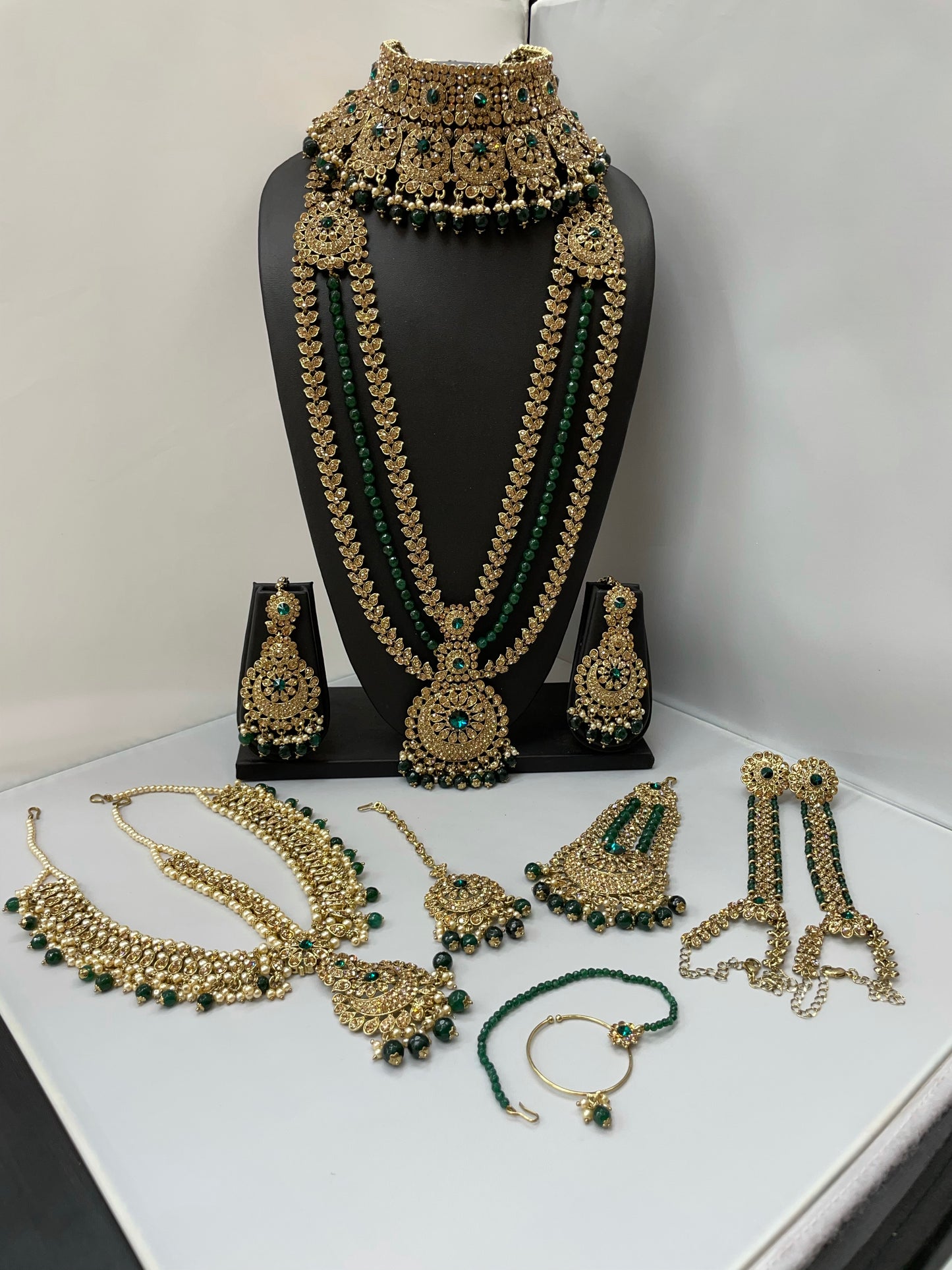 Bridal gold jewelry with emerald accents