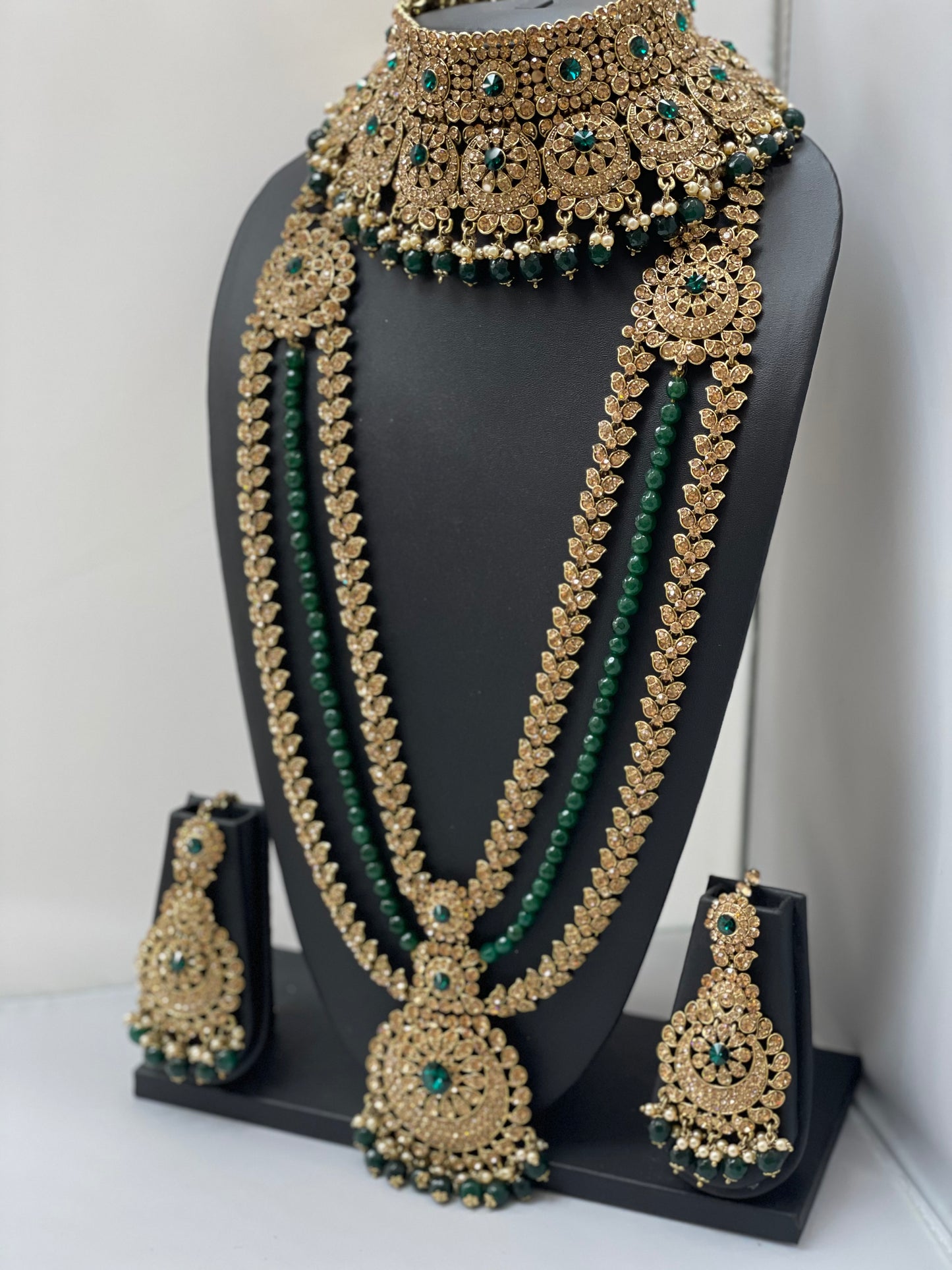 Bridal gold jewelry with emerald accents