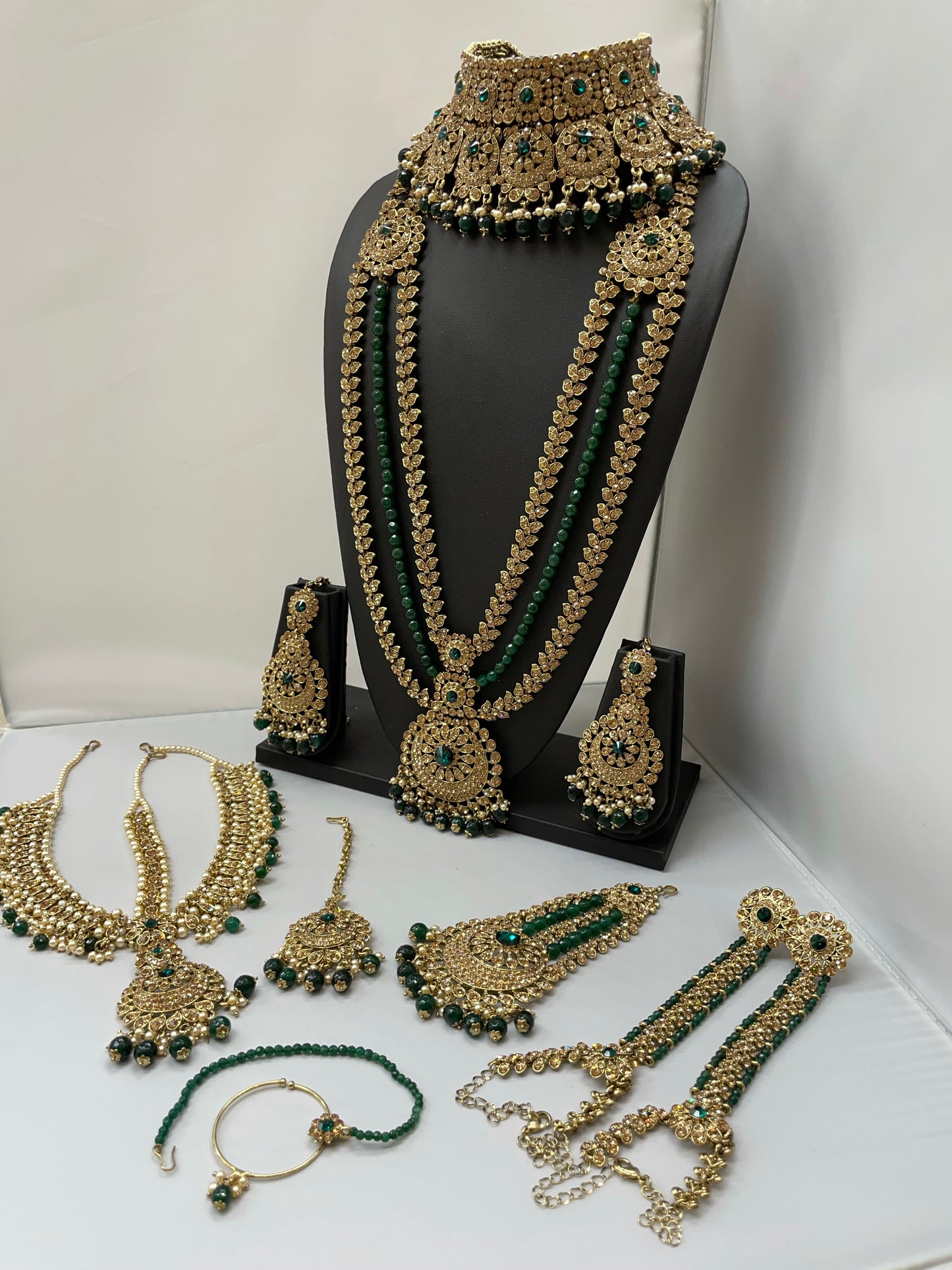 Bridal gold jewelry with emerald accents